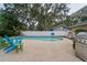 Backyard featuring a private swimming pool, patio area, lush landscaping, and an outdoor grill at 2273 Willowbrook Dr, Clearwater, FL 33764