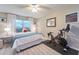 Inviting bedroom with a Peloton bike, plush bed, light walls, and wood-look flooring at 2273 Willowbrook Dr, Clearwater, FL 33764