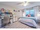Well-lit bedroom with a desk, chair, comfy bed, and crafting supplies on display at 2273 Willowbrook Dr, Clearwater, FL 33764