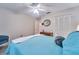 Bedroom with a ceiling fan, neutral walls, wood-look flooring and closet with louvered doors at 2273 Willowbrook Dr, Clearwater, FL 33764