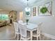 Dining area with stone fireplace, modern light fixture, and decor at 2273 Willowbrook Dr, Clearwater, FL 33764