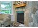 Stone fireplace with mantle and decor, complemented by a comfortable armchair at 2273 Willowbrook Dr, Clearwater, FL 33764