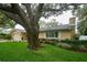 Lovely home showcasing a lush lawn, mature trees, and a welcoming front facade at 2273 Willowbrook Dr, Clearwater, FL 33764
