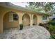 Inviting front porch with decorative columns and a beautifully landscaped walkway at 2273 Willowbrook Dr, Clearwater, FL 33764