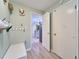 Hallway with storage leading to the kitchen featuring white cabinets and modern appliances at 2273 Willowbrook Dr, Clearwater, FL 33764