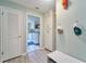 Hallway with storage leading to a laundry room featuring white cabinets and modern appliances at 2273 Willowbrook Dr, Clearwater, FL 33764