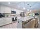 Bright kitchen featuring white cabinets, stainless appliances, granite counters, and a large island at 2273 Willowbrook Dr, Clearwater, FL 33764