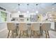 Modern kitchen with pendant lights, stainless steel appliances, white cabinets, and counter seating at 2273 Willowbrook Dr, Clearwater, FL 33764