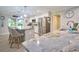 Bright kitchen with stainless steel appliances, island seating, granite counters, and modern pendant lighting at 2273 Willowbrook Dr, Clearwater, FL 33764