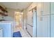 Spacious laundry room with a full refrigerator, cabinets, tiled floor, and washer/dryer at 2273 Willowbrook Dr, Clearwater, FL 33764