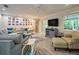 Cozy living room with sectional seating and a large window showcasing lush greenery at 2273 Willowbrook Dr, Clearwater, FL 33764