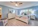 Bright main bedroom with a ceiling fan, light blue walls, and a window overlooking a serene backyard at 2273 Willowbrook Dr, Clearwater, FL 33764