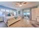 Bright main bedroom with a ceiling fan, access to the outside, light blue walls, and wood-look flooring at 2273 Willowbrook Dr, Clearwater, FL 33764