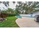 Relaxing pool area with comfortable seating, lush greenery, and a barbecue grill, ideal for summer gatherings at 2273 Willowbrook Dr, Clearwater, FL 33764