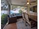 Inviting screened patio with a sectional sofa, ceiling fan, outdoor rug and dining furniture at 2273 Willowbrook Dr, Clearwater, FL 33764