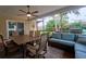 Relaxing screened-in patio with a dining table, seating area, and view of the backyard at 2273 Willowbrook Dr, Clearwater, FL 33764