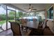 Relaxing screened-in patio with a ceiling fan, dining set, and comfortable outdoor seating at 2273 Willowbrook Dr, Clearwater, FL 33764