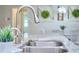 Close up of a kitchen sink with granite countertops, and view to the backyard at 2273 Willowbrook Dr, Clearwater, FL 33764