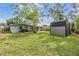 Spacious backyard featuring a shed, well-maintained lawn, and partial views of the home at 2526 W Jean St, Tampa, FL 33614