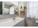 Stylish bathroom with a white vanity, decorative shelves, and large mirror at 2526 W Jean St, Tampa, FL 33614