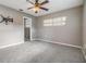 Cozy bedroom with neutral walls, a ceiling fan, and an open entry way to the bathroom at 2526 W Jean St, Tampa, FL 33614