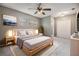 Serene primary bedroom with a ceiling fan, soft lighting, and an ensuite bathroom at 2526 W Jean St, Tampa, FL 33614