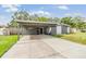 View of the exterior of a single-story home with a covered carport on a sunny day at 2526 W Jean St, Tampa, FL 33614