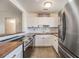 Modern kitchen with stainless steel appliances and white cabinets and butcher block countertops at 2526 W Jean St, Tampa, FL 33614