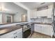 Bright kitchen featuring white cabinets, stainless steel appliances, and seamless flow to the living area at 2526 W Jean St, Tampa, FL 33614