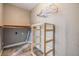 Laundry room with wooden shelving and a rack for hangers at 2526 W Jean St, Tampa, FL 33614