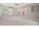 Bright living room with soft carpet and a white door leading to the exterior at 2526 W Jean St, Tampa, FL 33614