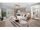 Living room featuring modern decor, a striped rug and ottomans, plus a view into the dining area at 2526 W Jean St, Tampa, FL 33614