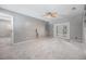 Spacious living room with neutral colors, leading to an outdoor area through glass doors at 2526 W Jean St, Tampa, FL 33614