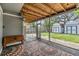 Screened-in patio featuring outdoor lighting and two storage buildings in the background at 2526 W Jean St, Tampa, FL 33614