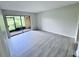Bedroom with gray floors and sliding glass doors that lead to an enclosed patio at 2625 State Road 590 # 1012, Clearwater, FL 33759