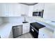 Modern kitchen with stainless steel appliances, white cabinets, and light countertops at 2625 State Road 590 # 1012, Clearwater, FL 33759