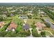 This stunning aerial view showcases a neighborhood, complete with mature trees and a serene pond at 2708 Coastal Range Way, Lutz, FL 33559