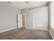Bedroom featuring carpet and ceiling fan, leading to an en-suite bathroom and large closet at 2708 Coastal Range Way, Lutz, FL 33559