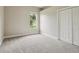 Bright bedroom with neutral carpet, a window overlooking the yard, and a double door closet at 2708 Coastal Range Way, Lutz, FL 33559