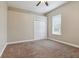 Cozy bedroom with neutral walls, carpet, a ceiling fan, closet and a bright window at 2708 Coastal Range Way, Lutz, FL 33559