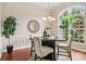 Cozy dining area offering hardwood floors, pendant lighting, and a decorative wall mirror at 2708 Coastal Range Way, Lutz, FL 33559