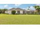 Spacious one-story home with a screened lanai and a large green lawn, perfect for outdoor activities at 2708 Coastal Range Way, Lutz, FL 33559