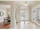 Welcoming foyer features decorative tile flooring, elegant lighting, and glass-paneled doors at 2708 Coastal Range Way, Lutz, FL 33559