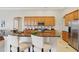 Kitchen with stainless steel appliances, granite counters, and custom wood cabinets offers ample storage at 2708 Coastal Range Way, Lutz, FL 33559