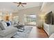 Bright living room featuring vaulted ceilings, modern furnishings and view of the lanai and pool area at 2708 Coastal Range Way, Lutz, FL 33559