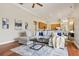 Spacious open-concept living room with hardwood floors, modern furniture, and seamless flow into the kitchen at 2708 Coastal Range Way, Lutz, FL 33559