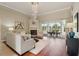Spacious living room with a fireplace, hardwood floors, and an open layout to the lanai at 2708 Coastal Range Way, Lutz, FL 33559