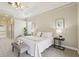 A large carpeted main bedroom boasts neutral paint, decorative wall art and a king bed with tufted headboard at 2708 Coastal Range Way, Lutz, FL 33559