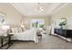 Bright main bedroom features a tray ceiling, neutral color palette, and sliding glass doors to the pool at 2708 Coastal Range Way, Lutz, FL 33559