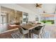 Covered outdoor patio with dining set, overlooking the backyard, and accessible to living room at 2708 Coastal Range Way, Lutz, FL 33559